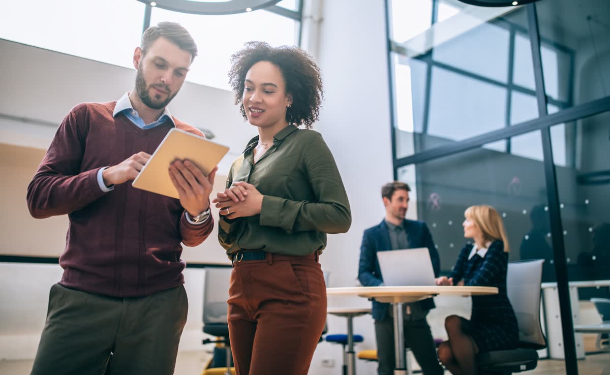 Colleagues talking in a modern office