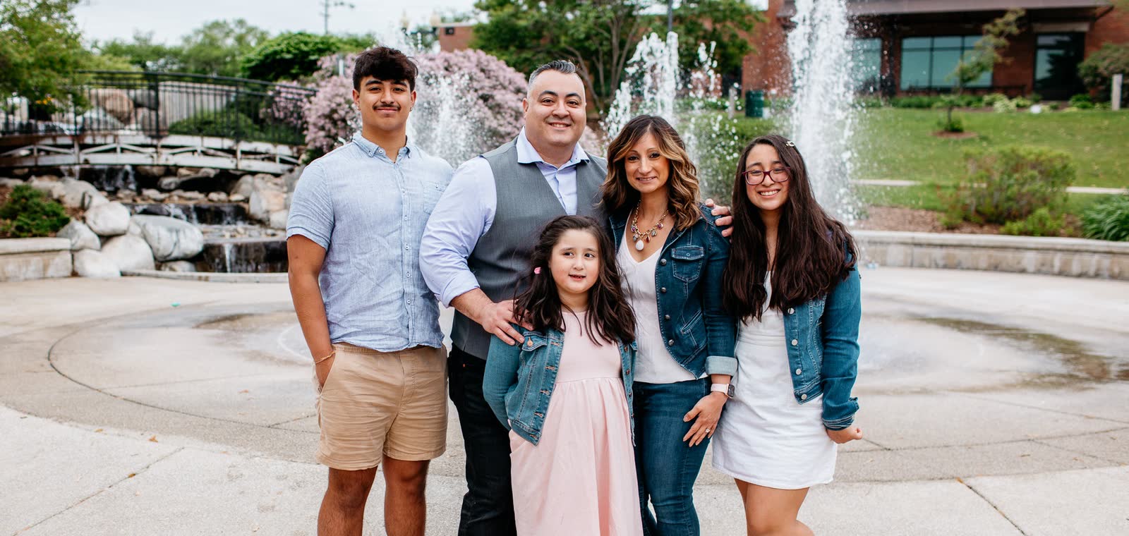 Eddie Valdes with his family by a fountain